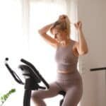 Young woman exercise on a bike in the room