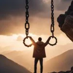 Man holding chains with mountainous sunset backdrop.