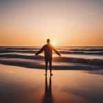 Person silhouetted against beach sunset.