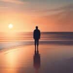 Person silhouette on beach at sunset.