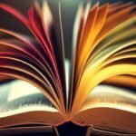 Open book with fanned pages on desk.